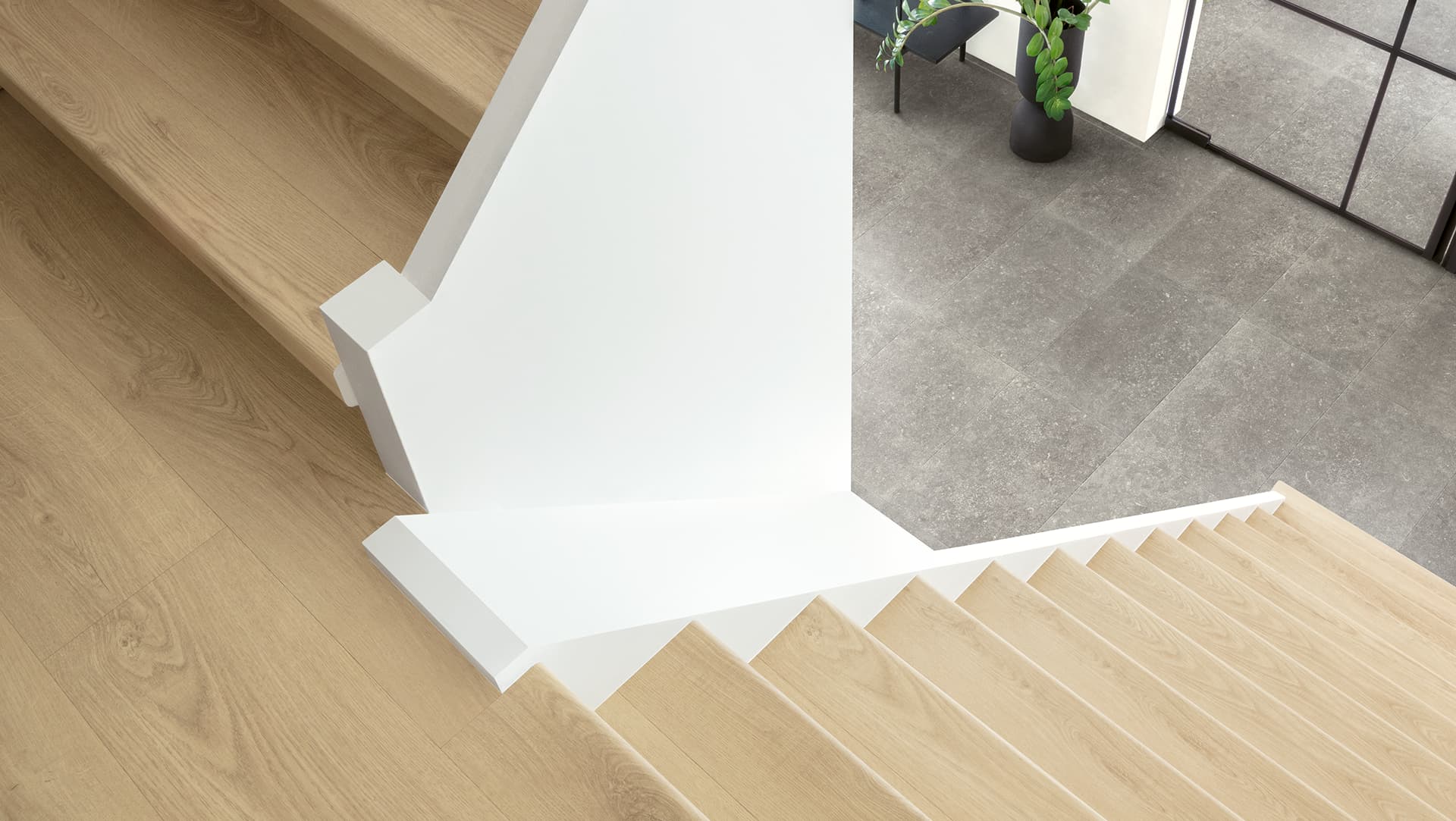 Beige laminate stairs with stair covers in white hall